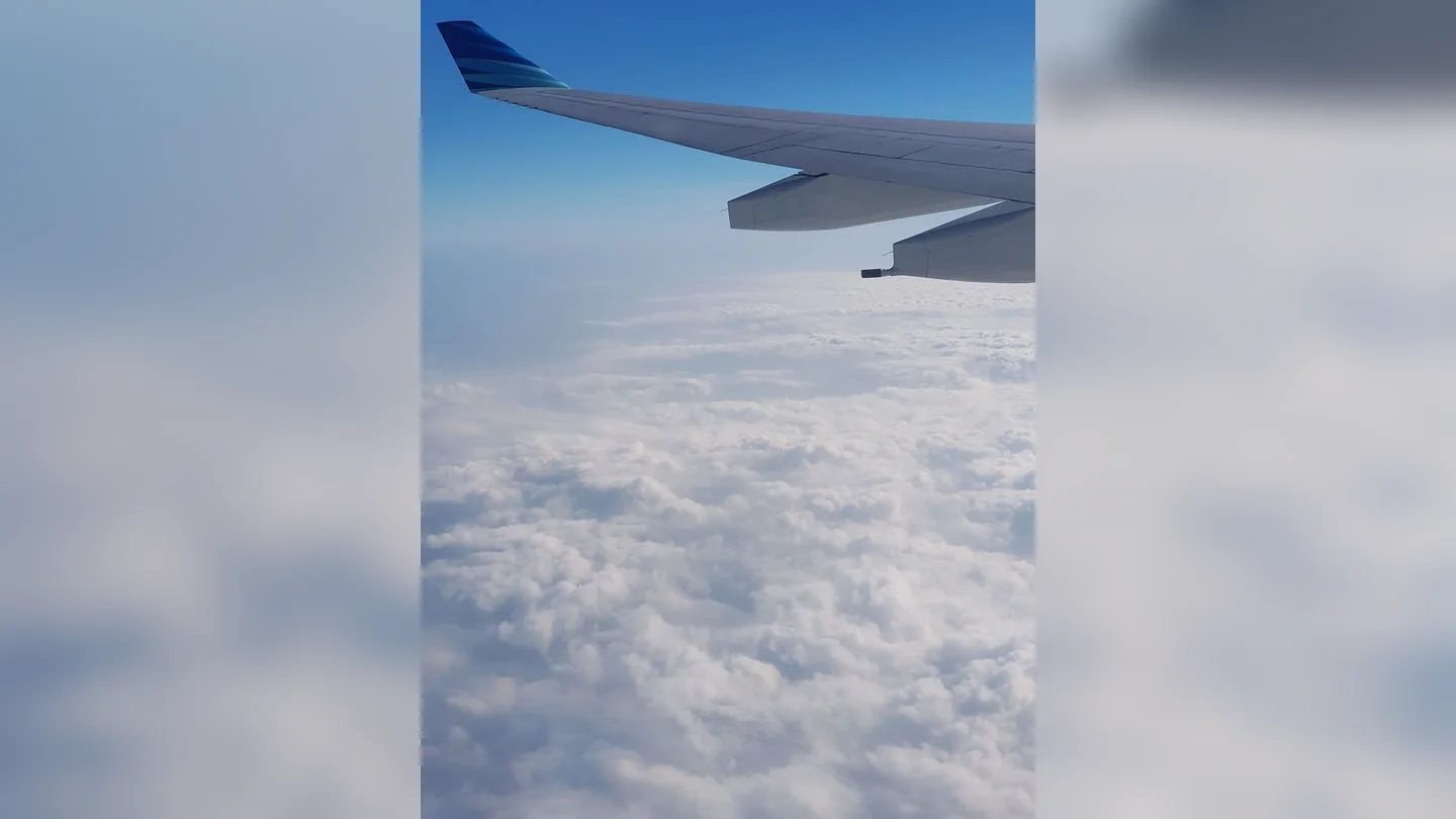 Airplane wing above the clouds