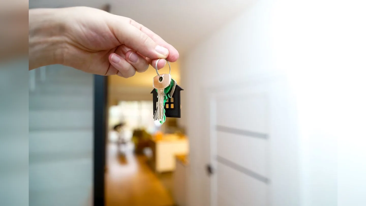 Hand holding a key inside a home
