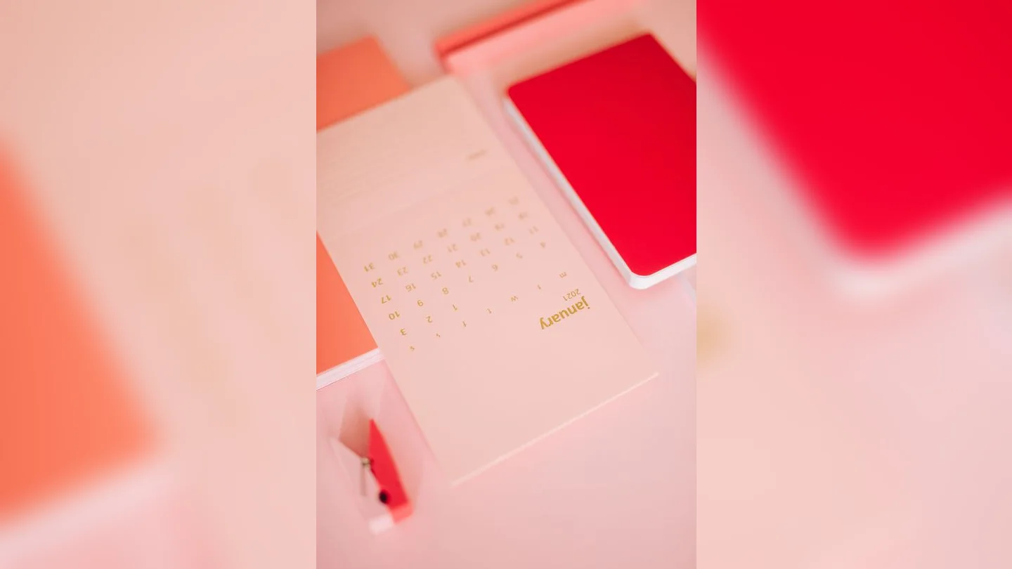 Calendar and notebook on a desk