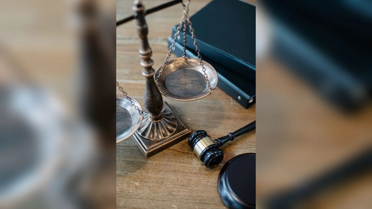 Scales of justice and a gavel on a desk