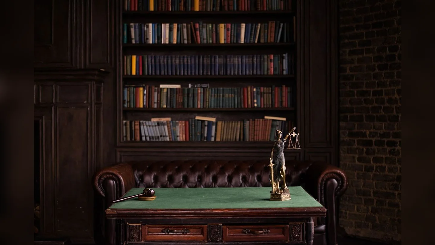 Law books, Lady Justice statue and gavel
