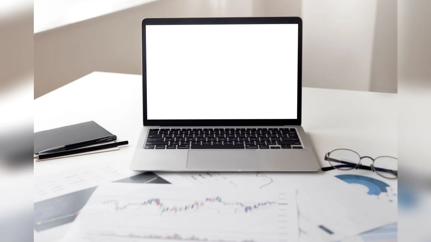 Laptop and documents on a desk