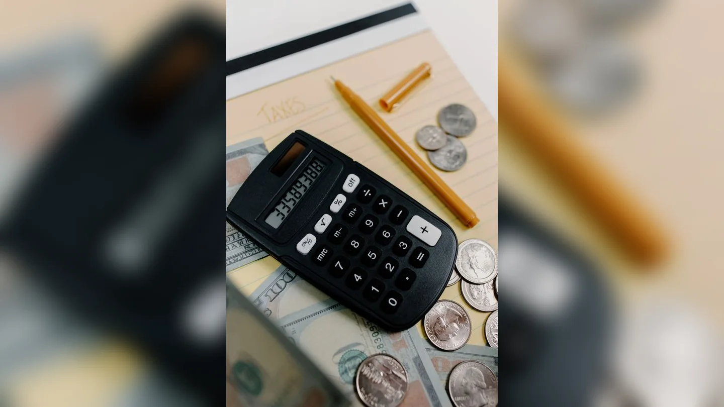 Calculator, money and notebook for budgeting