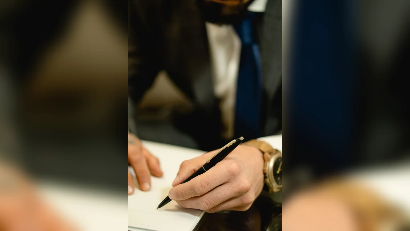 Close-up of a hand writing with a pen