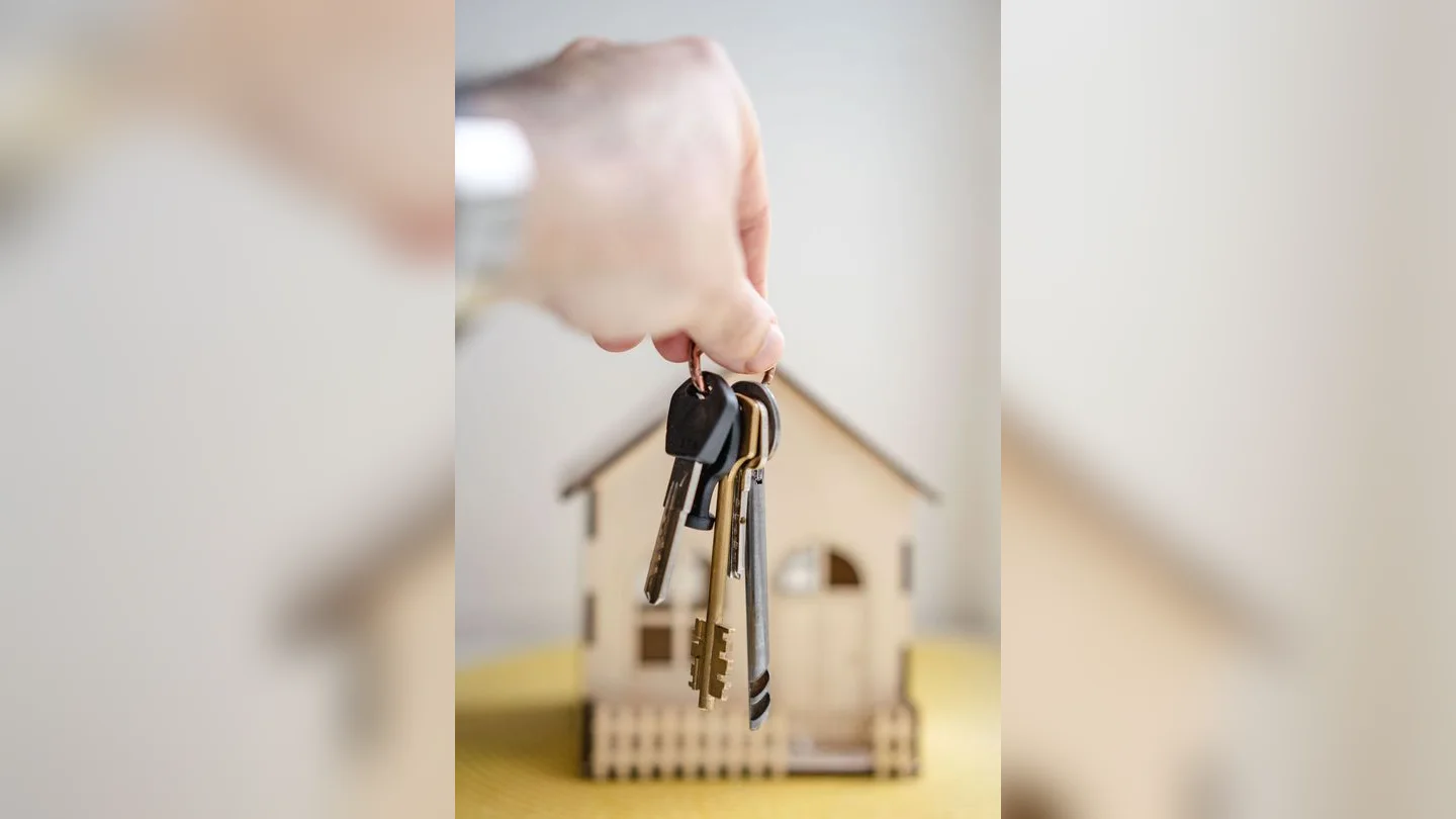 House keys beside a model home