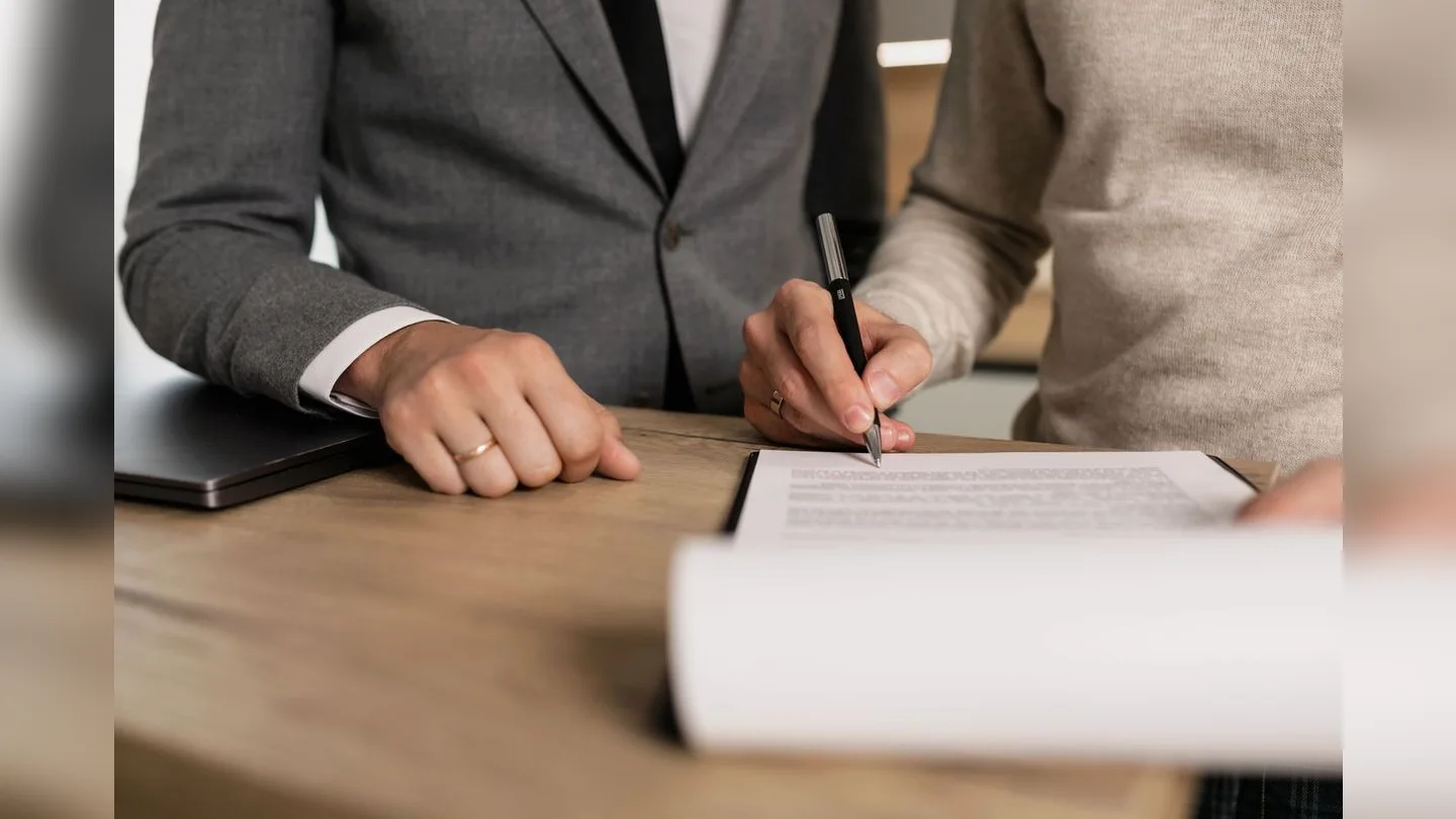 Hands completing a document together