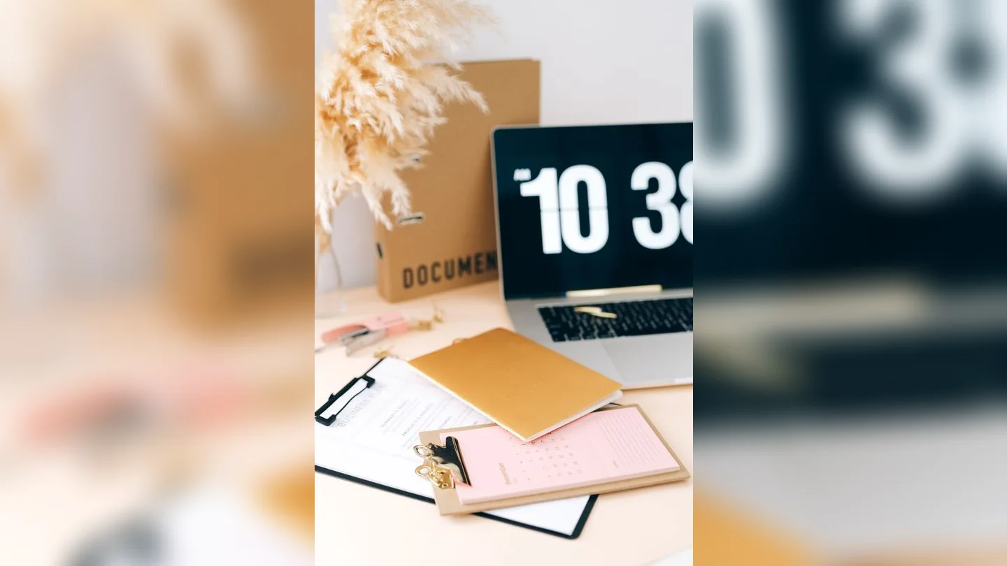 Documents, calendar and laptop on a desk