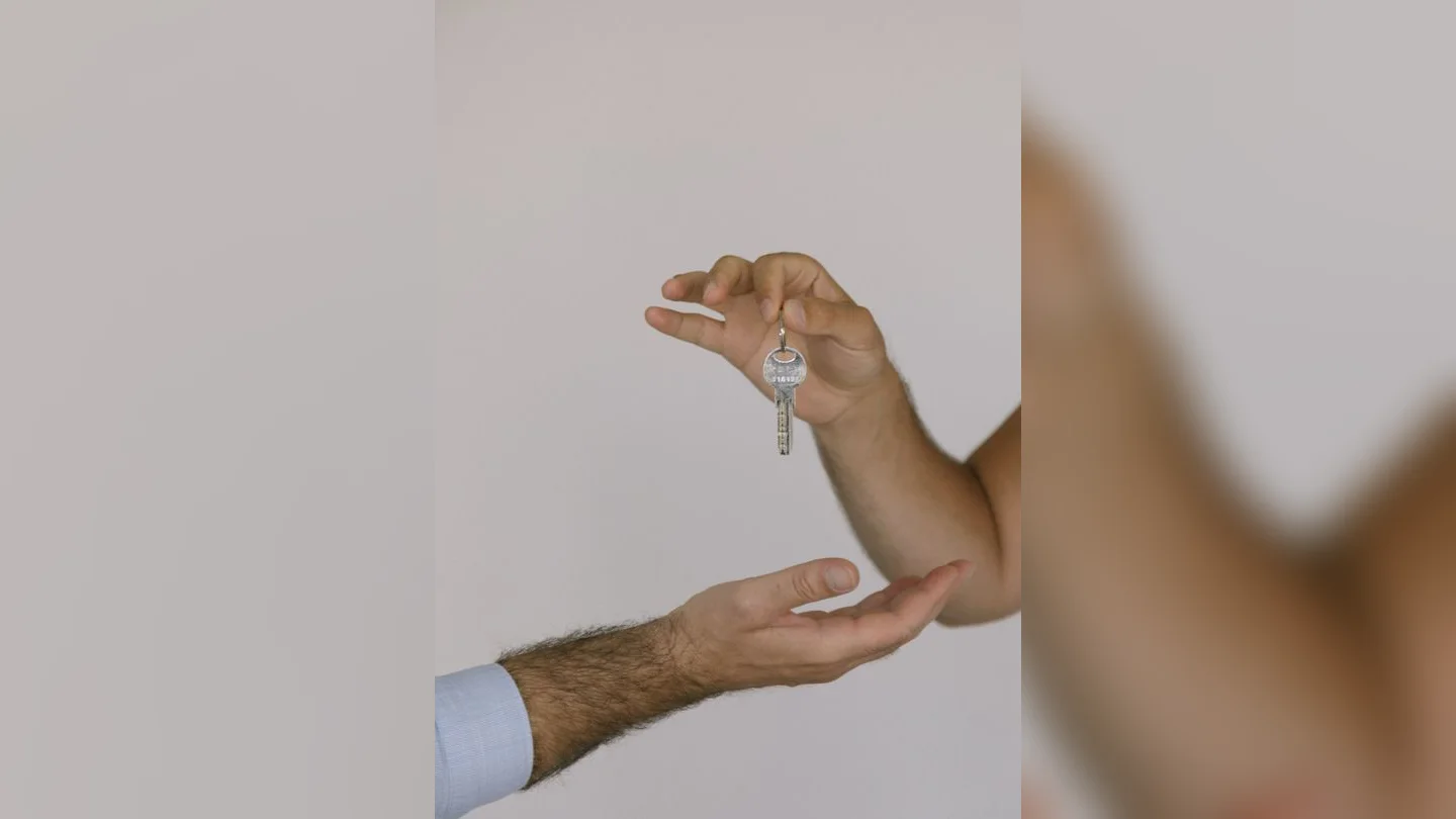Hands exchanging house keys